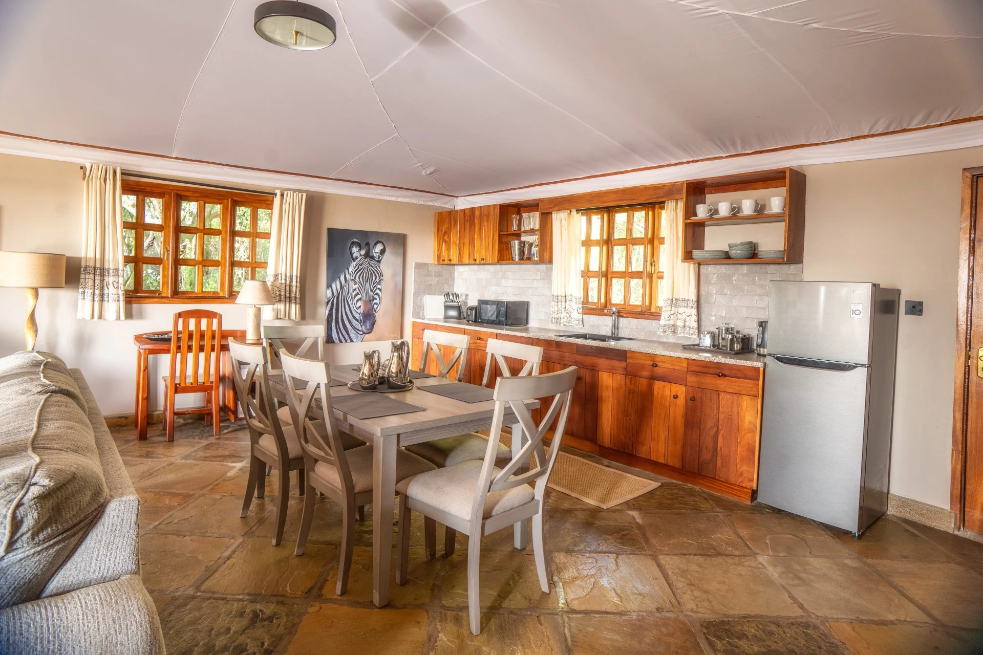 Dining area and kitchen inside the Family Chalet at Mara West Camp