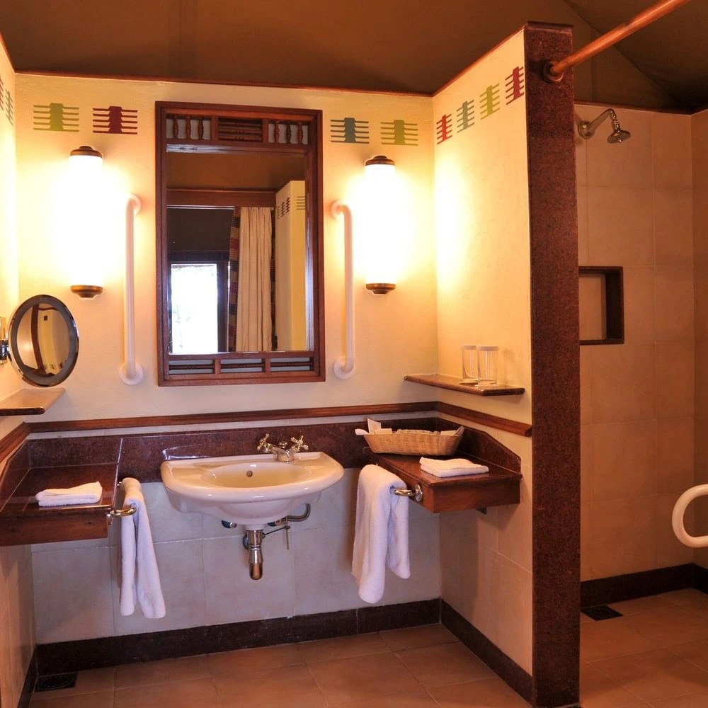Morani Deluxe Tent bathroom with double vanity at Sweetwaters Serena Camp, styled with the elegance of luxury resorts in Asia